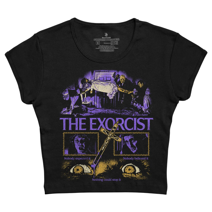 Black short-sleeved t-shirt featuring a purple and gold graphic of ’the exorcist’ movie poster with the taglines “nobody expected it” and “nothing could stop it.”