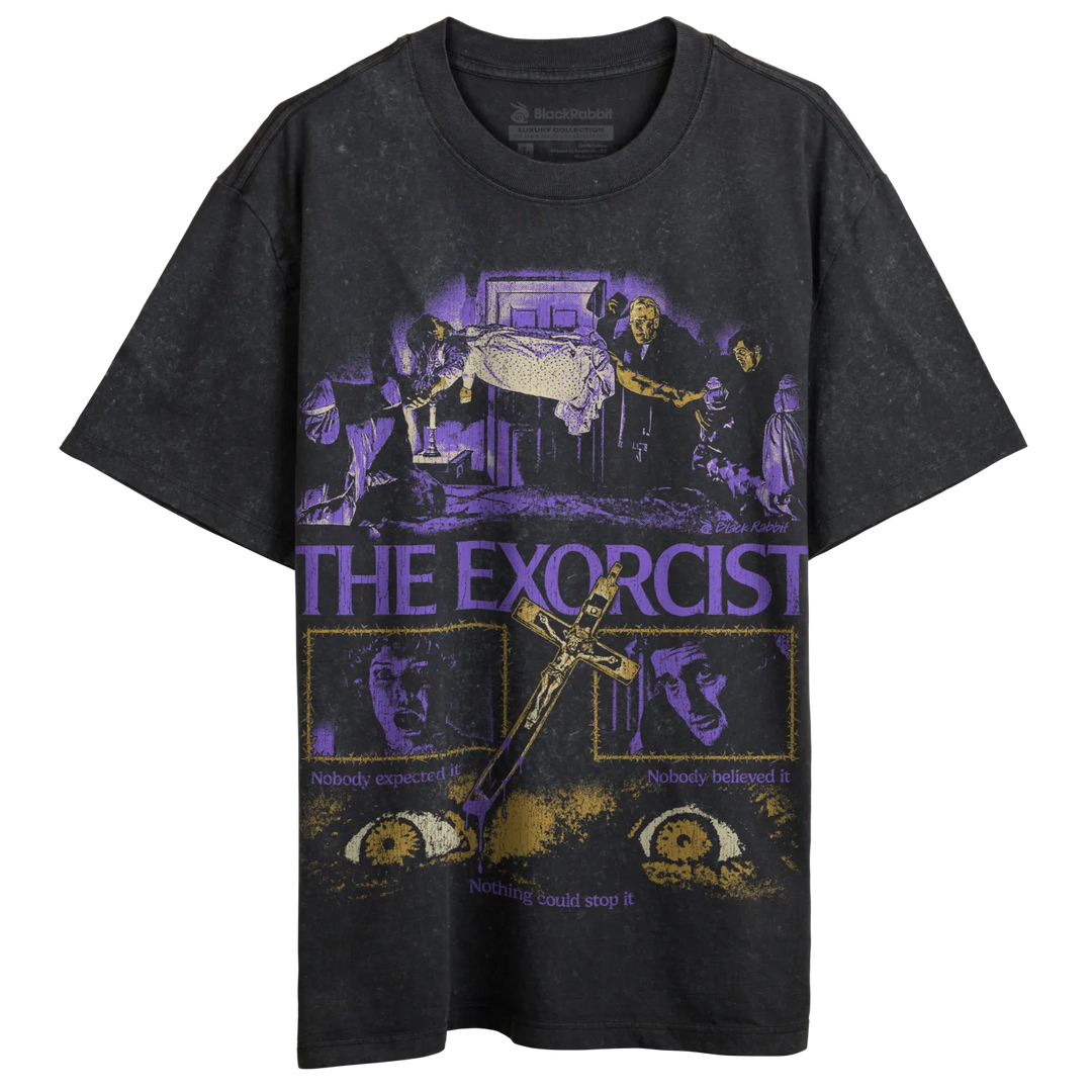 Black crewneck t-shirt with a purple and yellow graphic print of ’The Exorcist’ movie scenes and a crucifix.