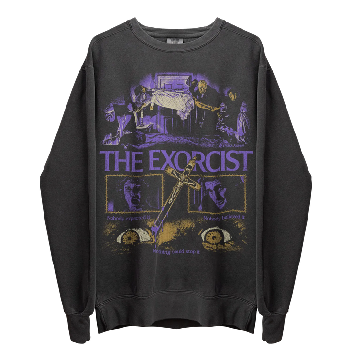 A dark gray long-sleeved crewneck sweatshirt featuring a graphic print from ’The Exorcist’ in purple and gold tones.