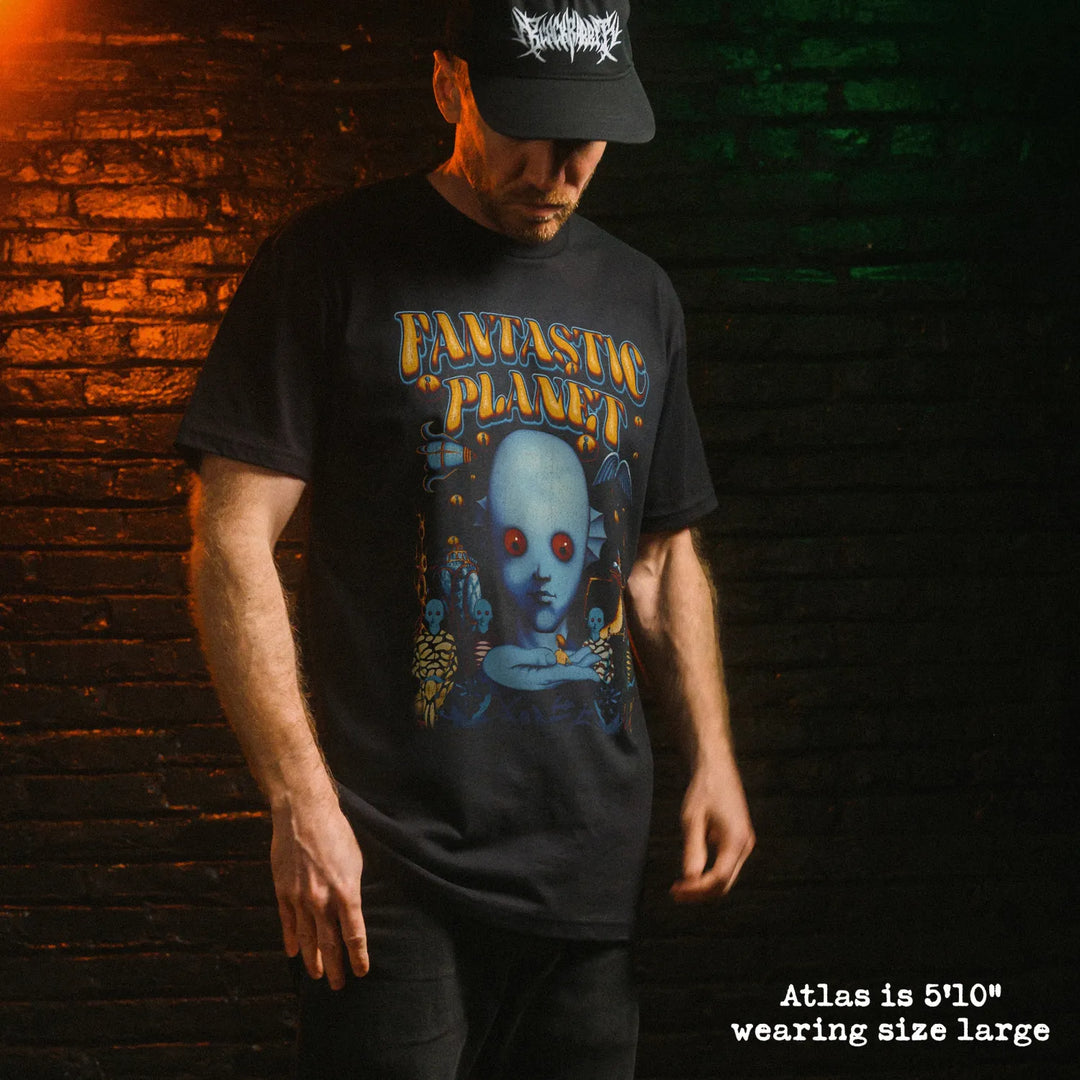 Male model wearing black premium tee with fantastic planet graphic 