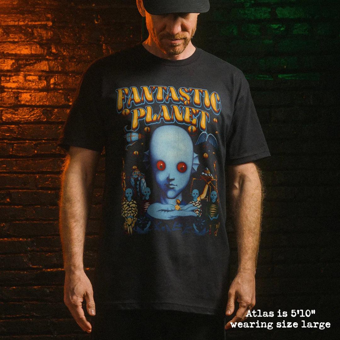 Male model wearing black premium tee with fantastic planet graphic 