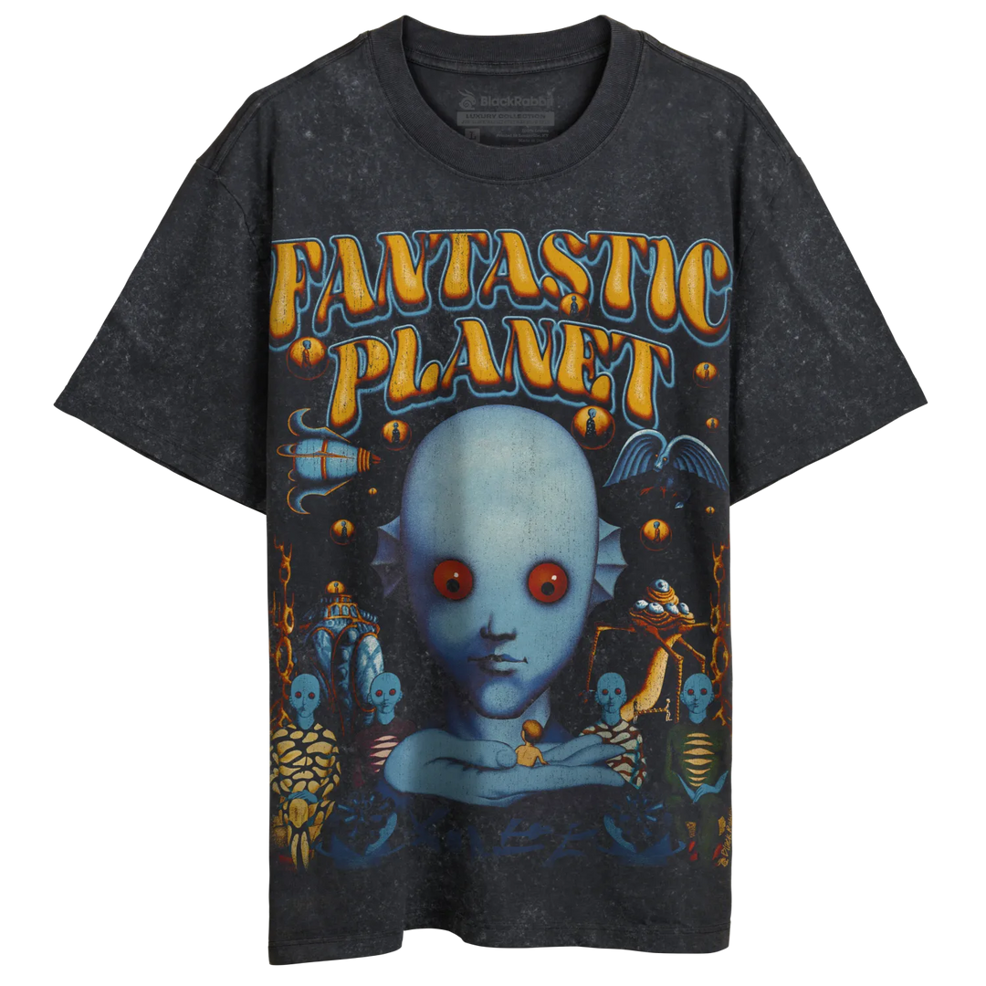 A vintage-style black t-shirt with a colorful graphic print of a blue-skinned, red-eyed alien creature and other fantastical elements, featuring the text ’FANTASTIC PLANET’.