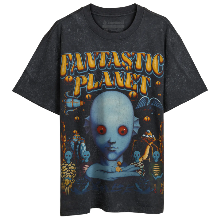 A vintage-style black t-shirt with a colorful graphic print of a blue-skinned, red-eyed alien creature and other fantastical elements, featuring the text ’FANTASTIC PLANET’.