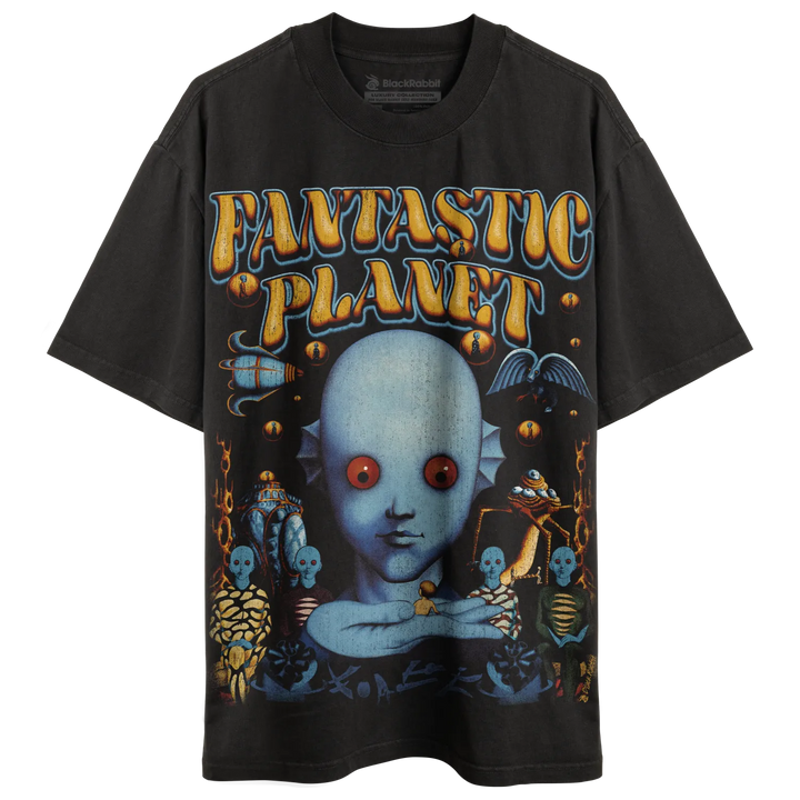 A black graphic t-shirt featuring a large, colorful illustration of an alien creature with red eyes and other fantastical elements.