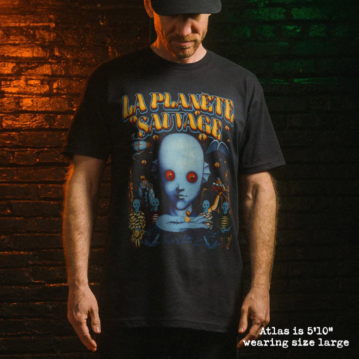 Male model wearing black premium tee with fantastic planet graphic 