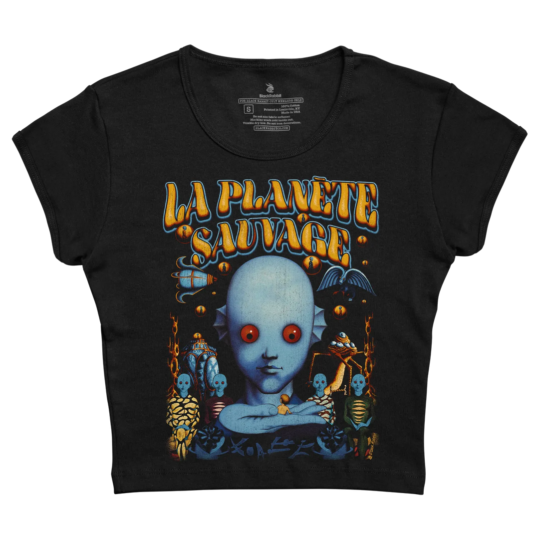 Black short-sleeved t-shirt featuring a vibrant graphic of a blue alien face with red eyes and the text ’la planete sauvage’ in stylized orange lettering above it.