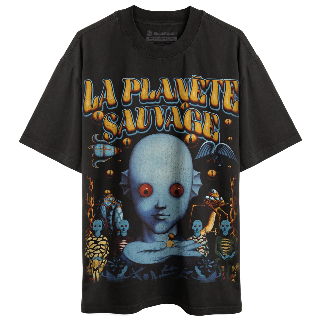 Black short-sleeved t-shirt with a colorful graphic print featuring a blue alien-like figure with red eyes and the text ’LA PLANÈTE SAUVAGE’.