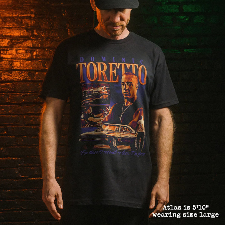 Male model wearing black premium tee with toretto graphic 