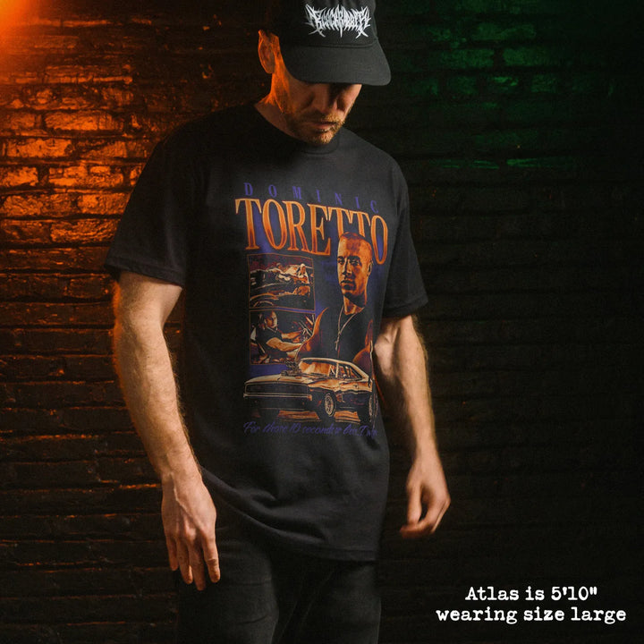 Male model wearing black premium tee with toretto graphic 