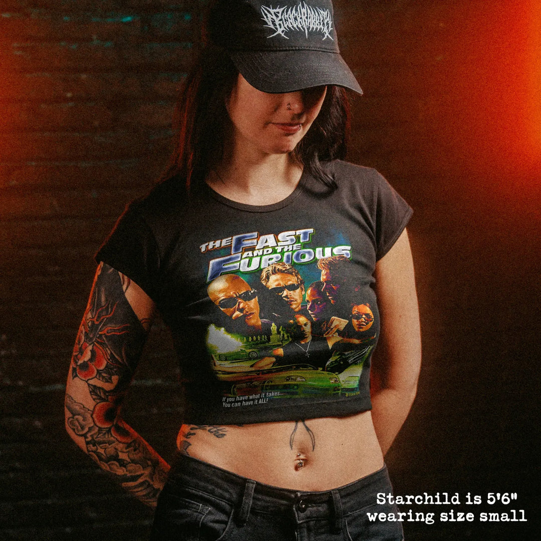Female model wearing cropped baby tee with fast and furious graphic
