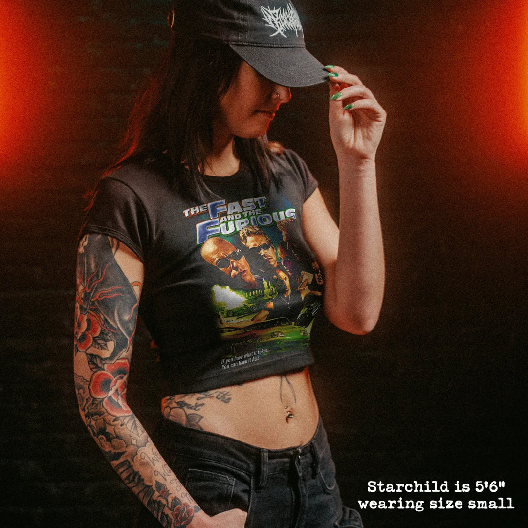 Female model wearing cropped baby tee with fast and furious graphic
