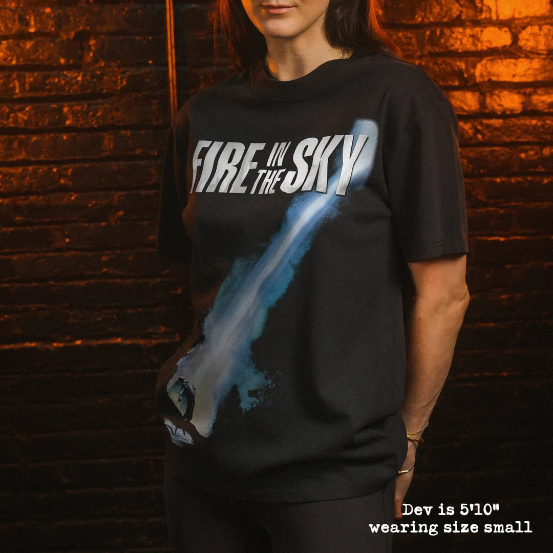 Model wearing heavy tee with fire in the sky graphic 