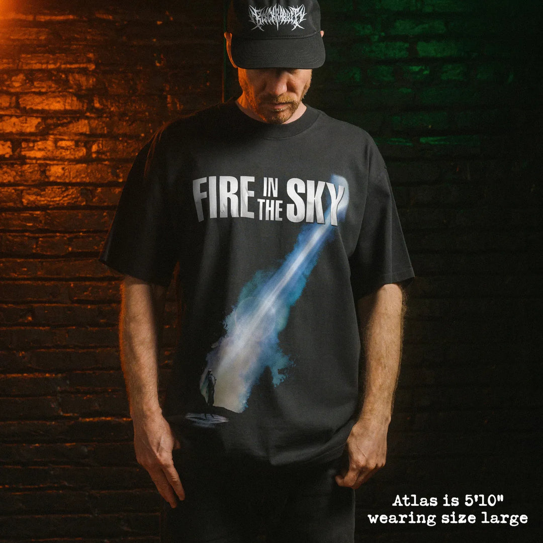 Model wearing heavy tee with fire in the sky graphic 