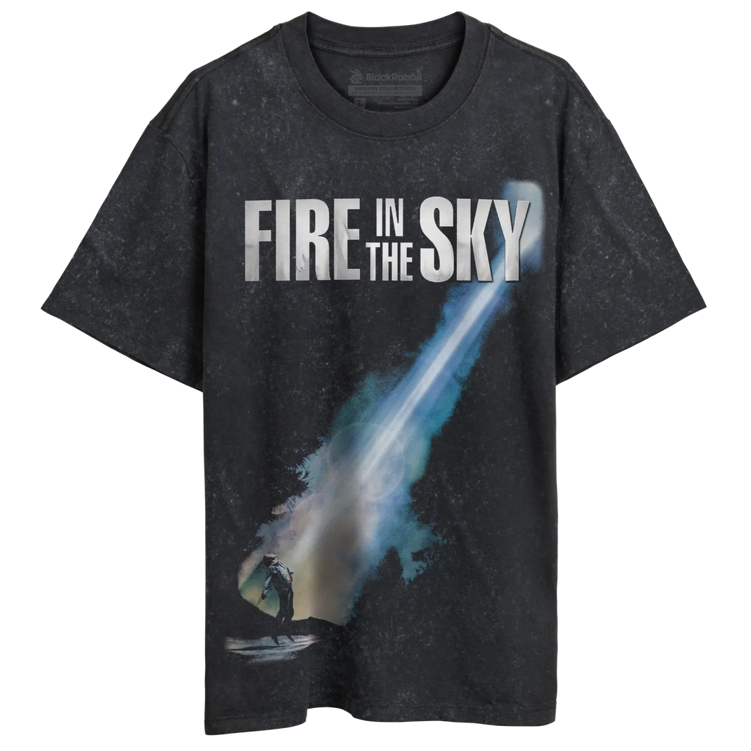 Dark grey t-shirt with a blue and white graphic of a streaking object and the text ’FIRE IN THE SKY’.