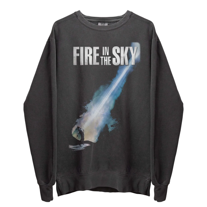 A dark gray crewneck sweatshirt with a graphic of a comet streaking across the front.