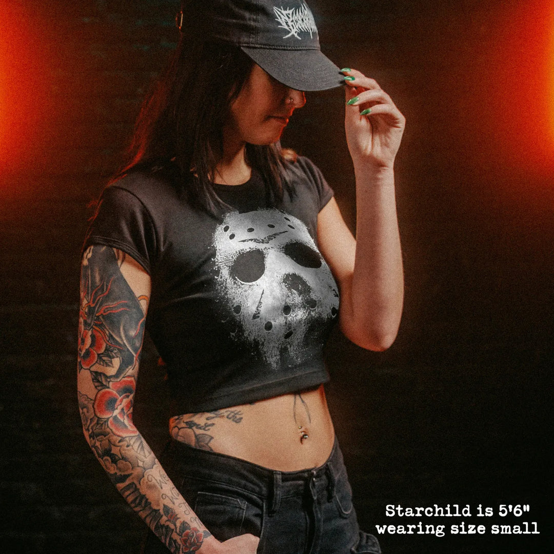 Female model wearing cropped baby tee with jason mask graphic
