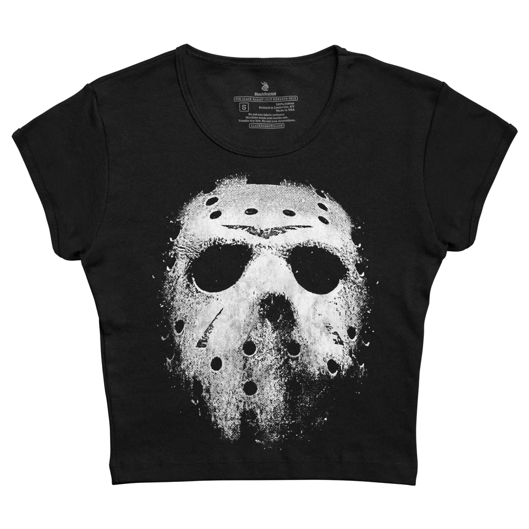 Black short-sleeved crop top featuring a distressed white graphic of the iconic hockey mask from friday the 13th.
