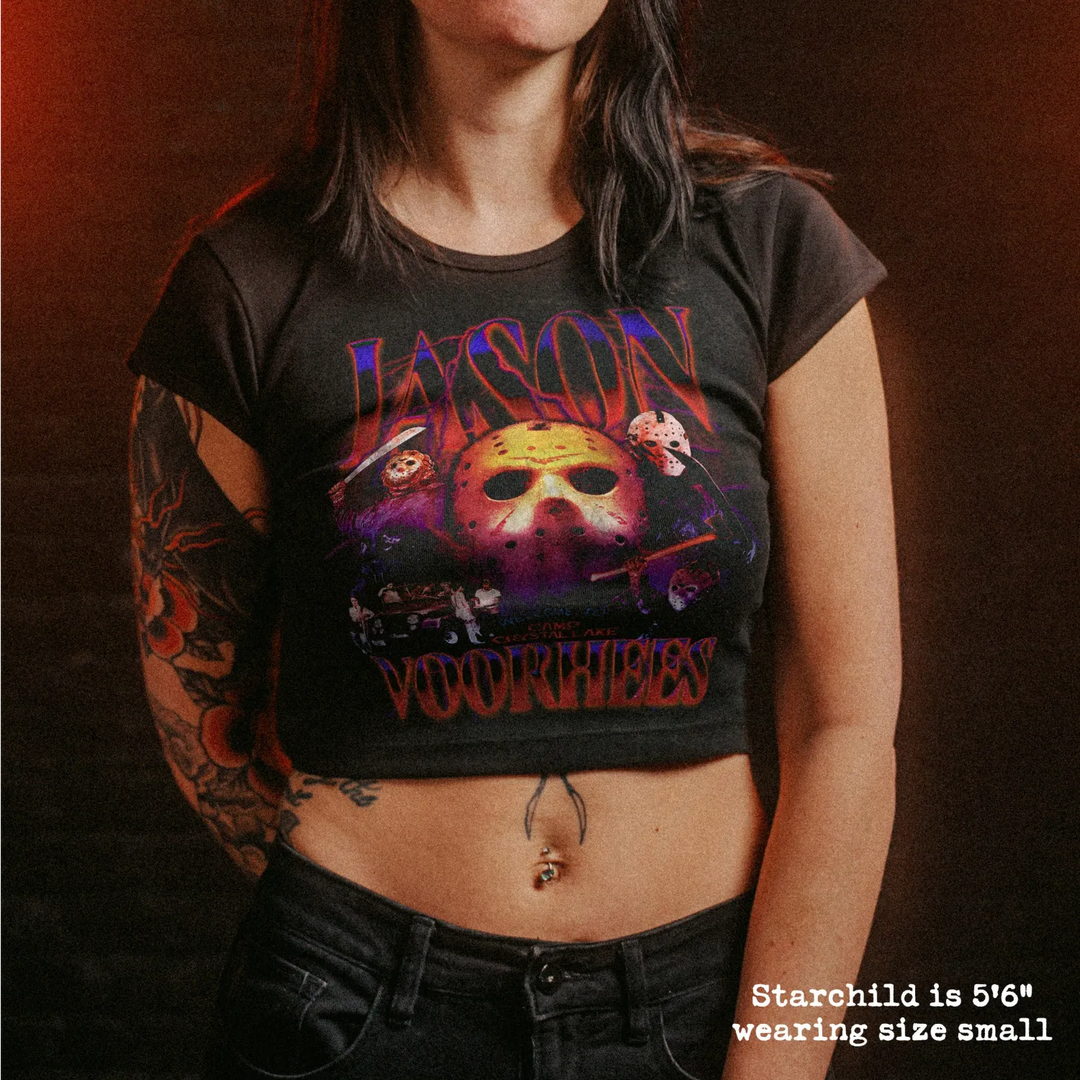 Female model wearing cropped baby tee with jason voorhees graphic
