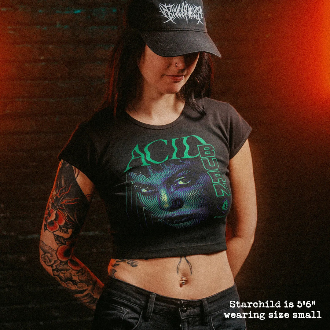 Female model wearing cropped baby tee with Acid Burn graphic
