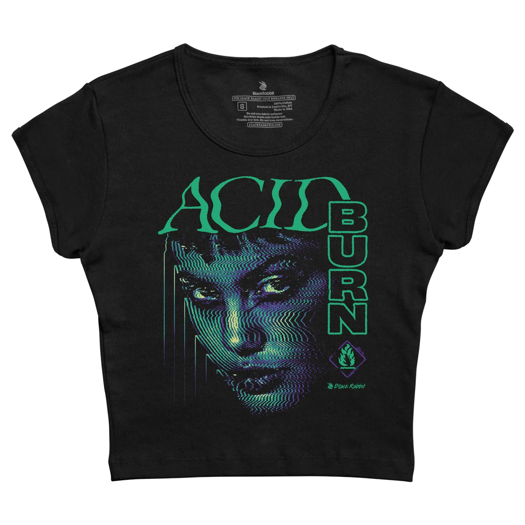 Black cropped t-shirt featuring a vibrant neon green and blue digital-art face design with the words ’acid burn’ printed vertically in matching glowing letters.