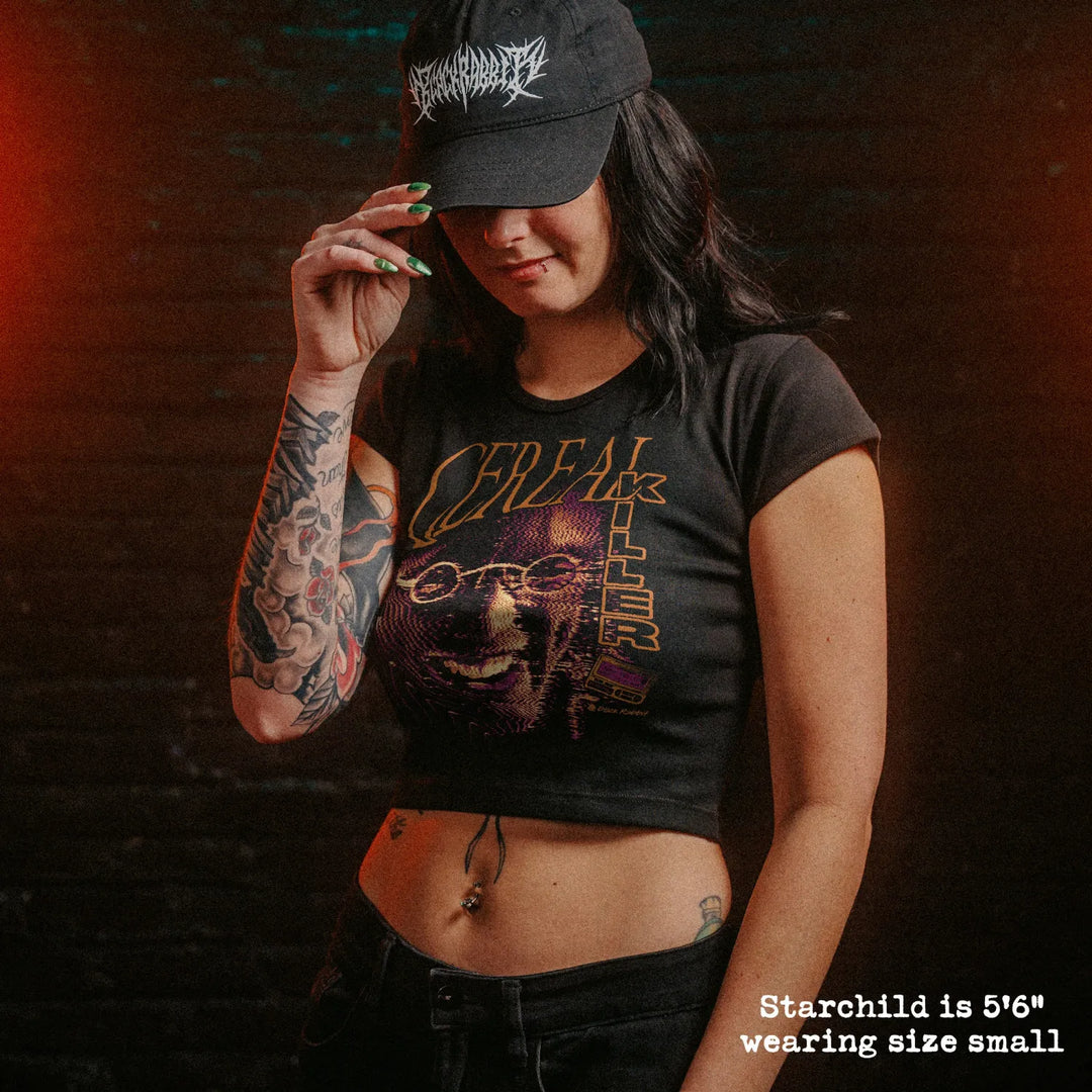 Model wearing cropped baby tee with cereal killer graphic.
