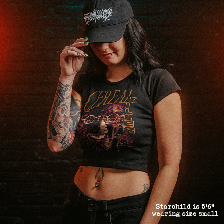 Model wearing cropped baby tee with cereal killer graphic.
