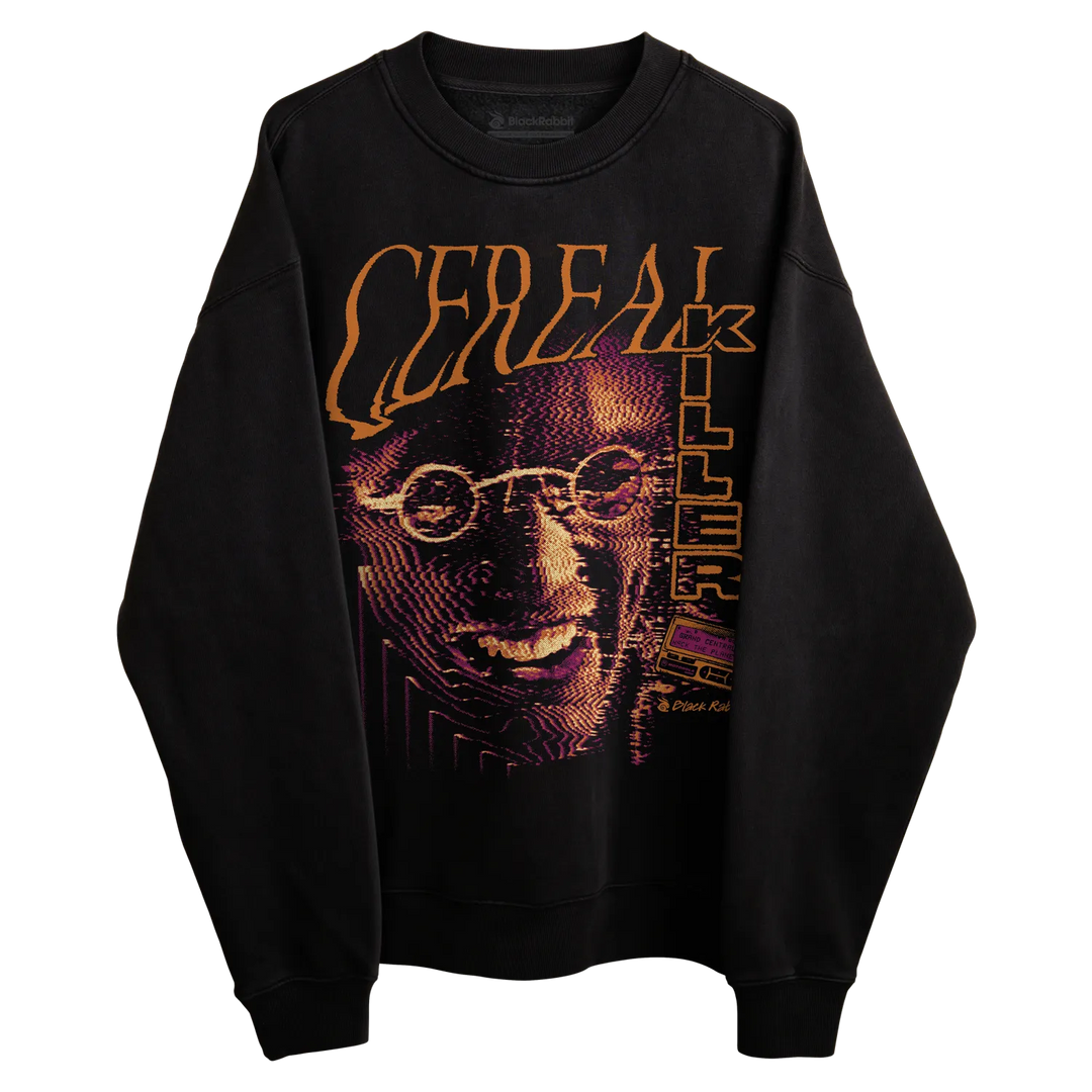 Black crewneck sweatshirt with large Cereal Killer graphic featuring orange lettering, purple halftone artwork, and a VHS tape detail. 
