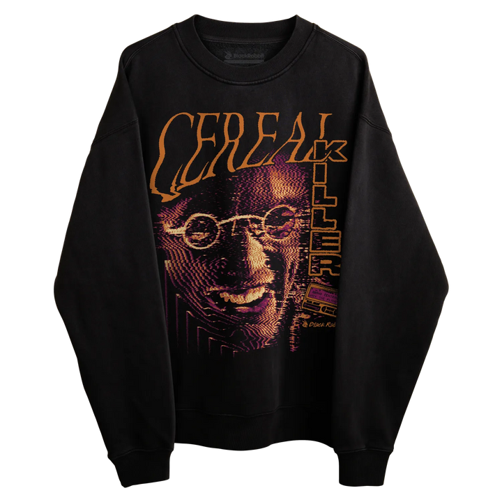 Black crewneck sweatshirt with large Cereal Killer graphic featuring orange lettering, purple halftone artwork, and a VHS tape detail. 