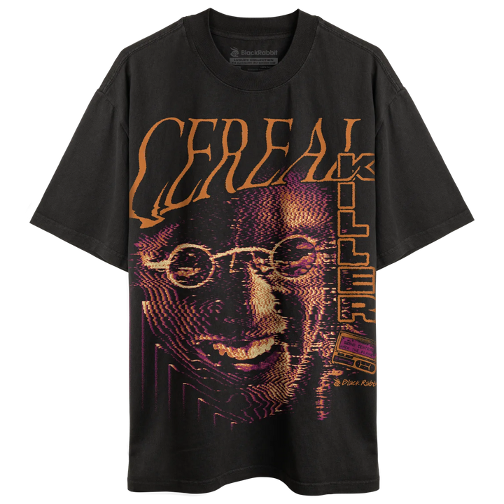 Faded black oversized T-shirt with jumbo Cereal Killer graphic, orange lettering, purple halftone face artwork, and retro VHS detail. 