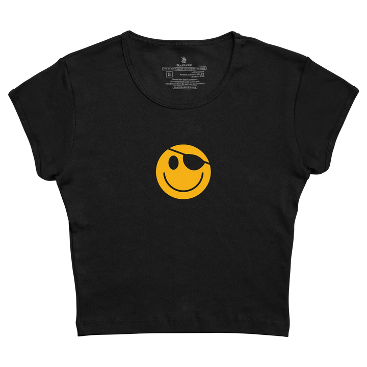 Black cropped tee featuring a bold yellow smiley face with an eye patch.