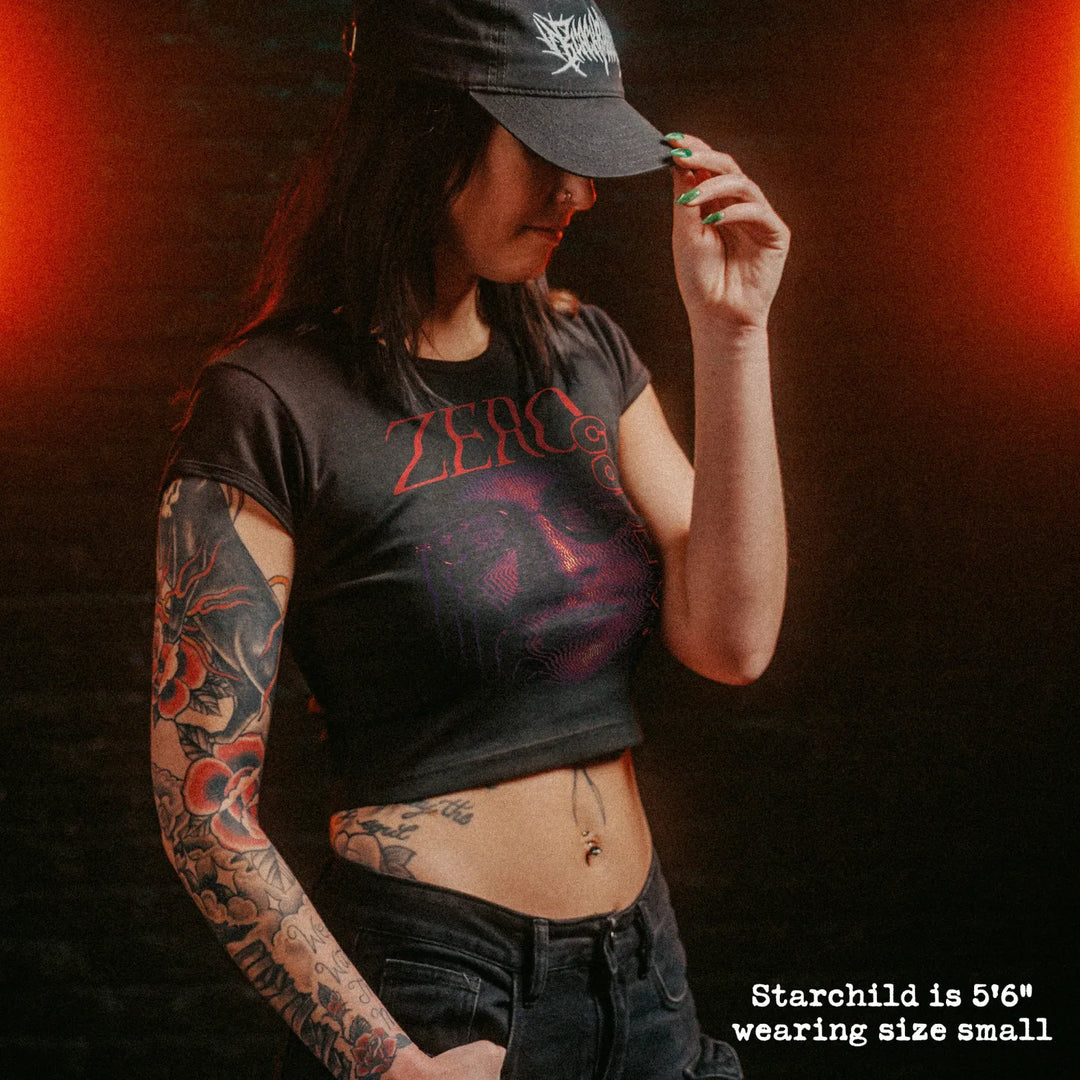 Model wearing cropped baby tee with zero cool graphic.
