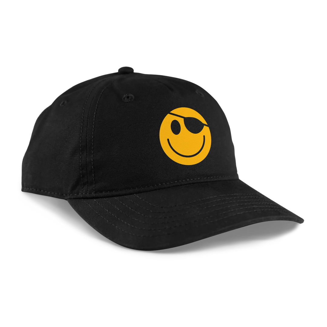 Black baseball cap featuring a bold yellow smiley face with an eyepatch.