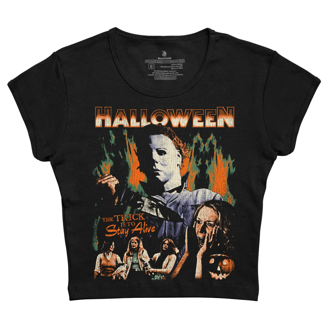 Black short-sleeved t-shirt featuring a graphic print of the ’halloween’ movie poster with michael myers and the tagline “the trick is to stay alive.”