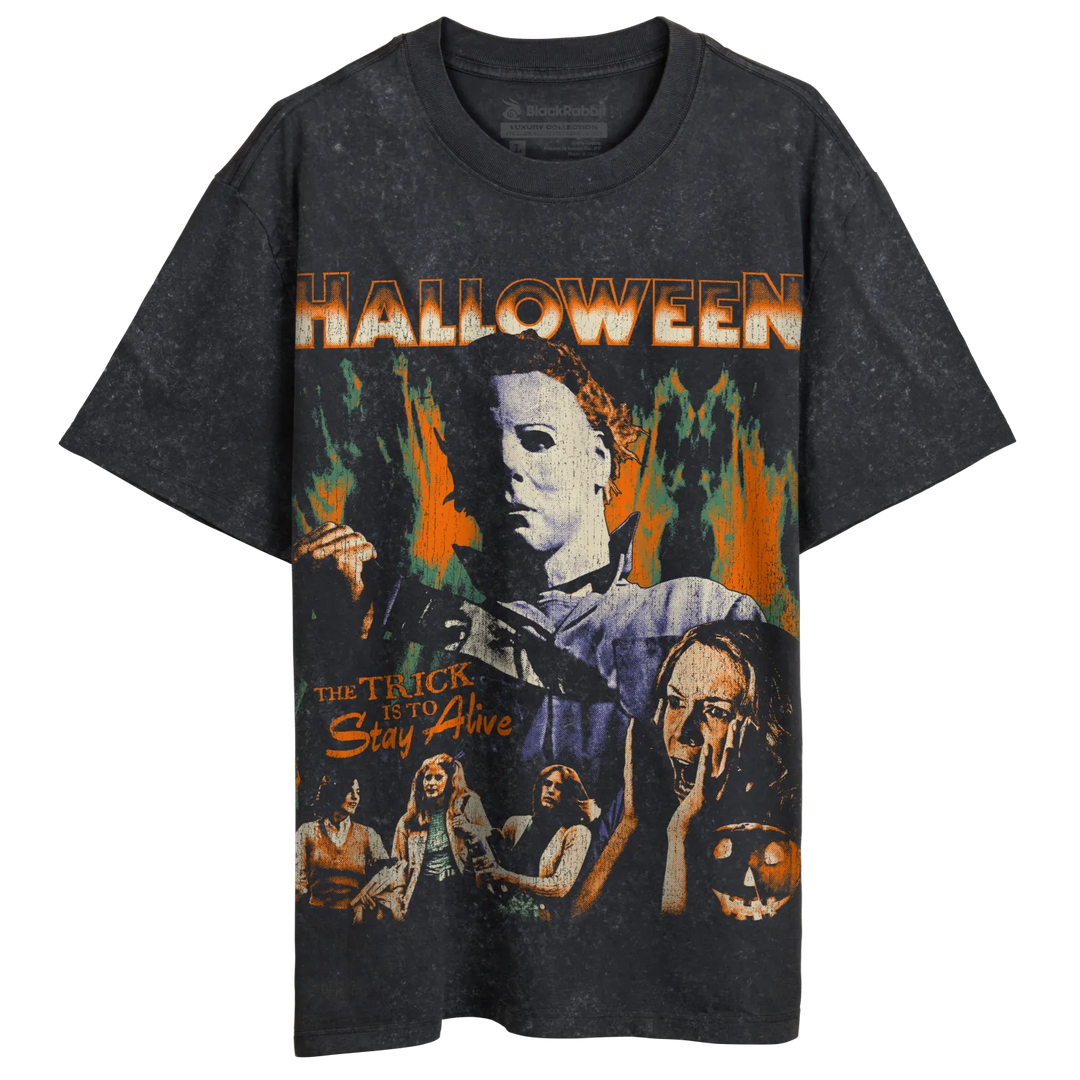 A dark gray, short-sleeved t-shirt with a vintage-style graphic print featuring Michael Myers from the movie ’Halloween’ and the text ’THE TRICK IS TO Stay Alive.’