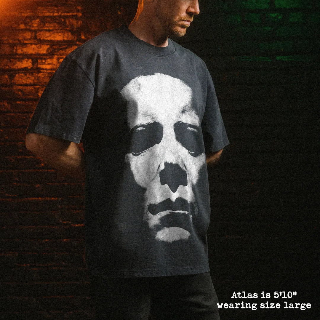 Male model wearing stone wash heavy tee with michael myers mask graphic 