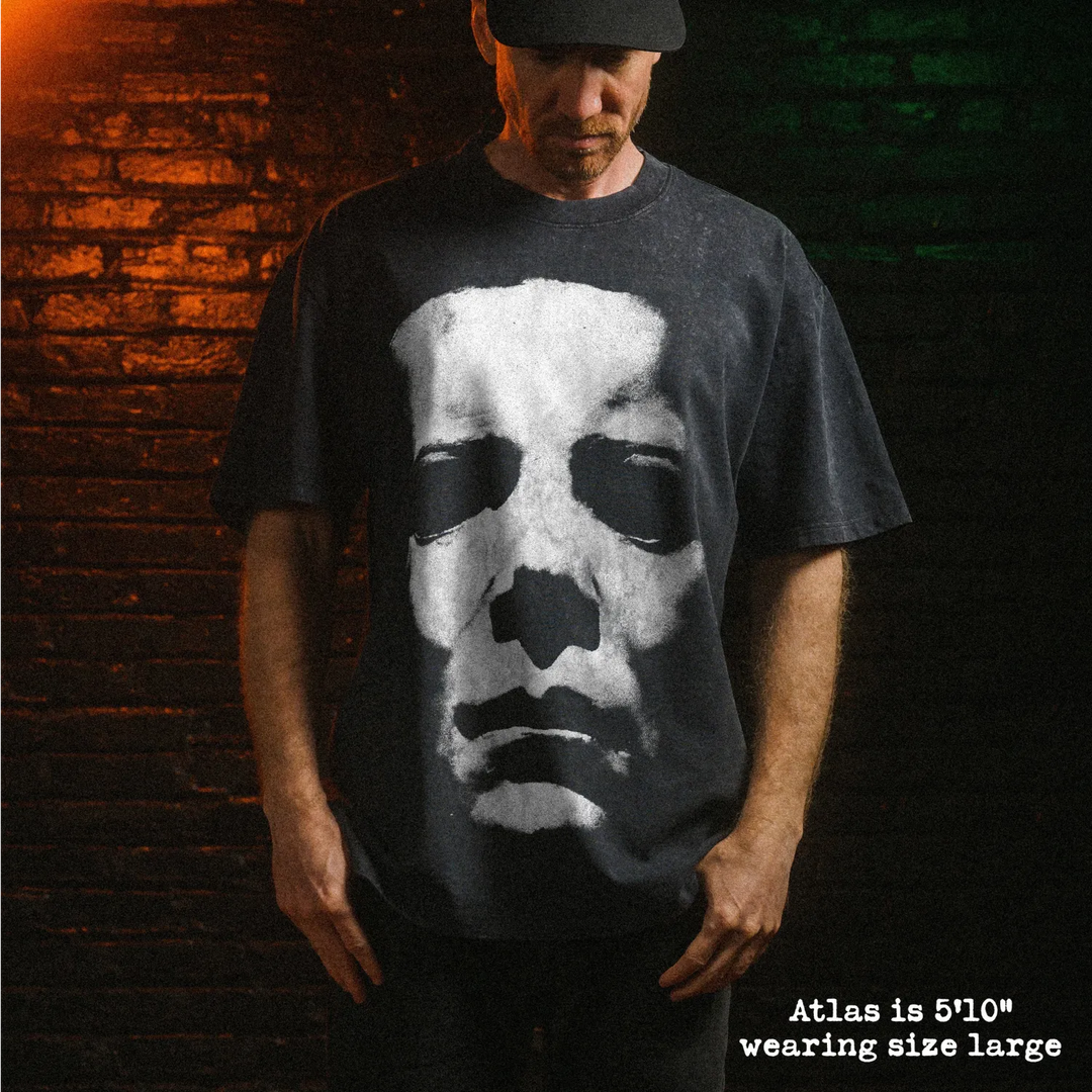 Male model wearing stone wash heavy tee with michael myers mask graphic 