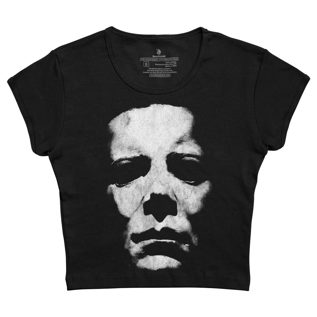 Black short-sleeved crop top featuring a high-contrast black and white graphic of michael myers’ face from the halloween franchise.
