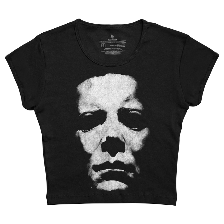 Black short-sleeved crop top featuring a high-contrast black and white graphic of michael myers’ face from the halloween franchise.