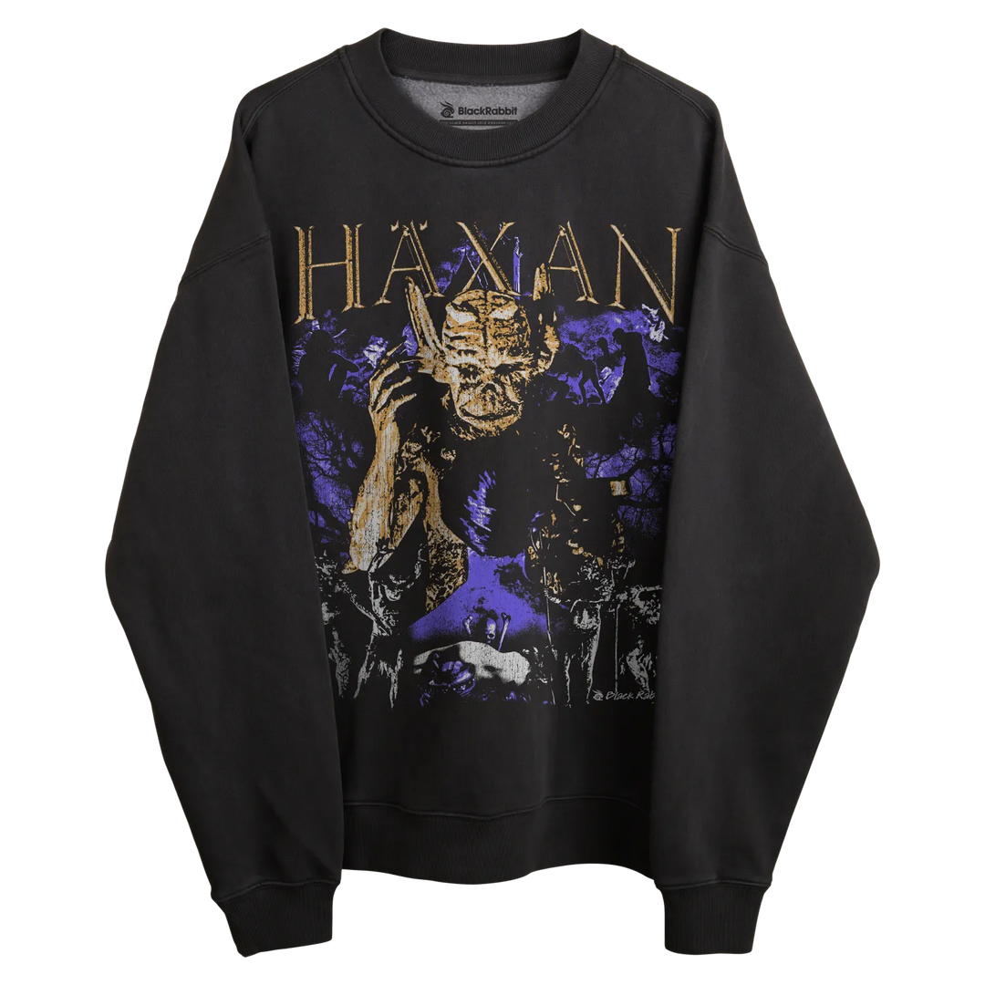 Black sweatshirt with purple and gold graphic design featuring a demon-like figure.