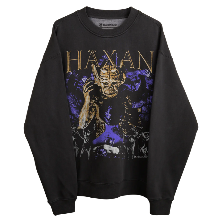 Black sweatshirt with purple and gold graphic design featuring a demon-like figure.