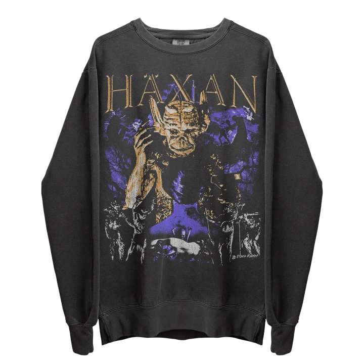 A dark gray long-sleeve sweatshirt with a ’Haxan’ graphic featuring a demon-like figure and purple and gold accents.