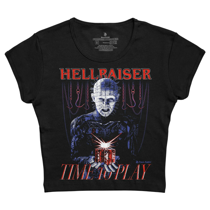 Black short-sleeved t-shirt featuring a graphic of the character pinhead from hellraiser holding a red box with chains hanging behind him, printed in blue and red tones.
