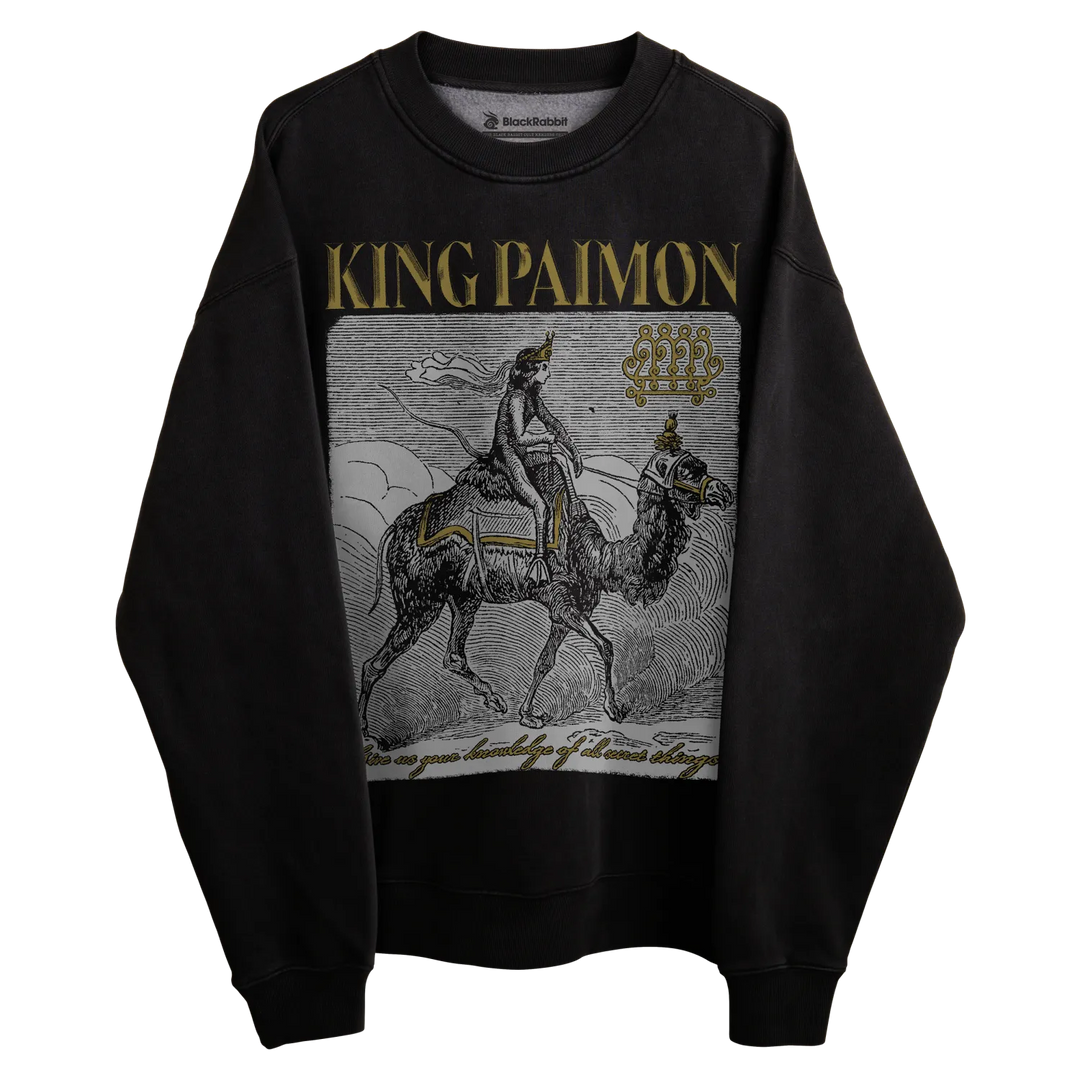 Black sweatshirt with ’king paimon’ graphic and text design.