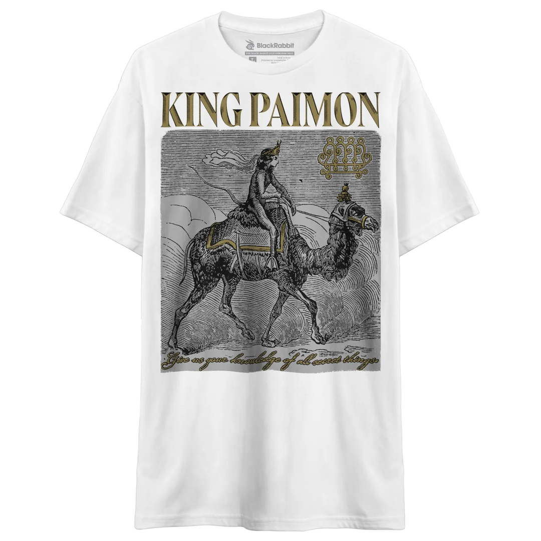 A white short-sleeved t-shirt with a vintage-style graphic print of a figure riding a camel, and the text ’KING PAIMON’ above it.