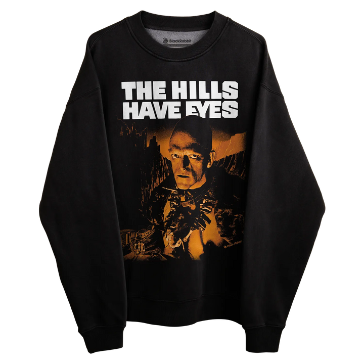 Black crewneck sweatshirt with ’the hills have eyes’ graphic and text design.
