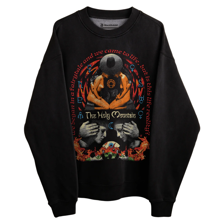 Black long-sleeved sweatshirt with graphic design featuring two faces and a central eye, floral patterns at the bottom hem.