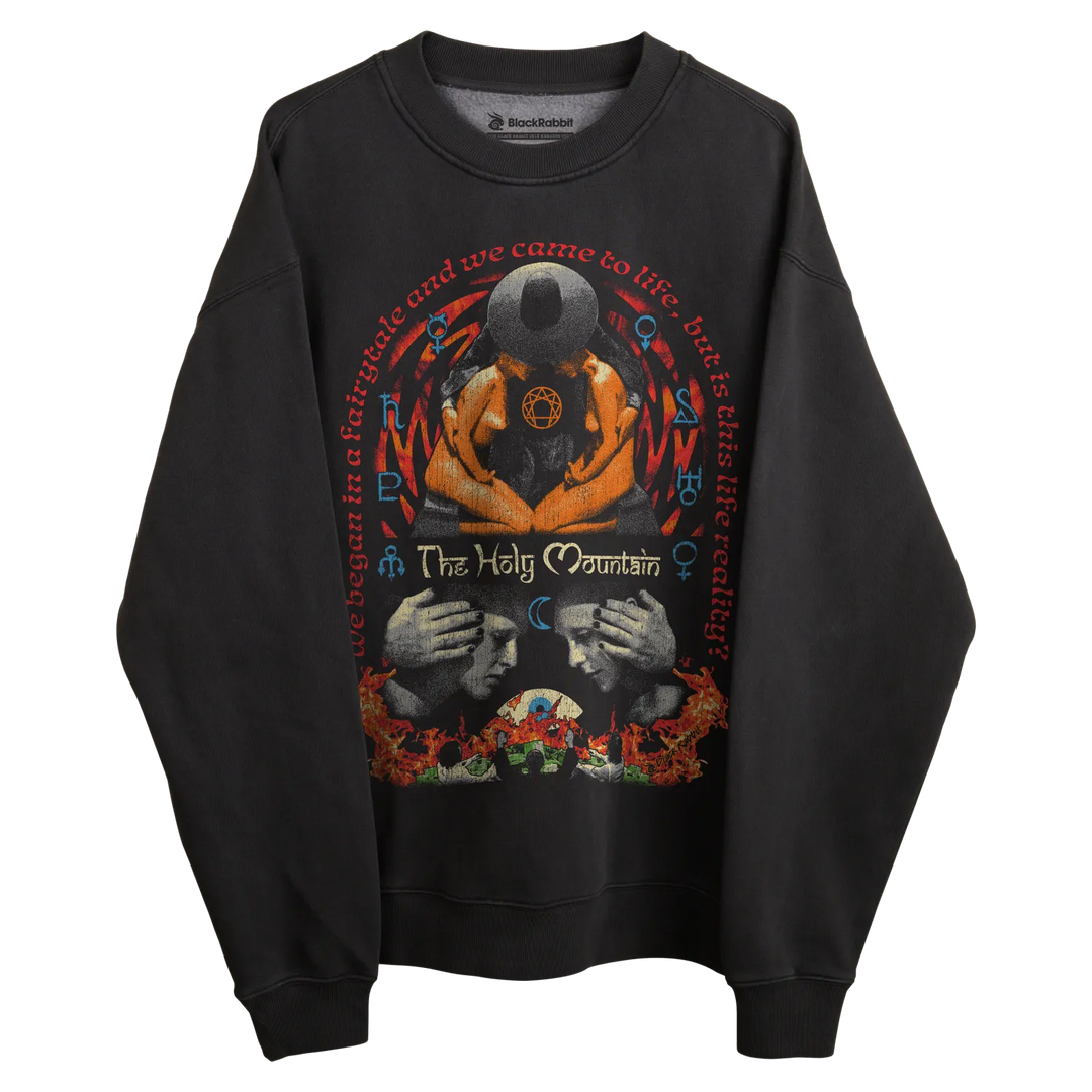 Black sweatshirt with graphic design featuring two faces and a skull, orange hands holding the skulls.