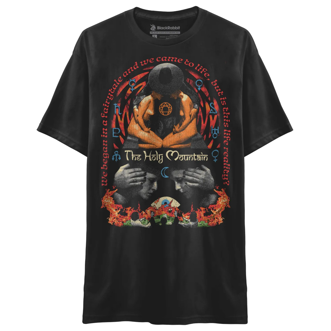 Black t-shirt with graphic design of two hands holding a skull, flames and text ’the holy mountain’