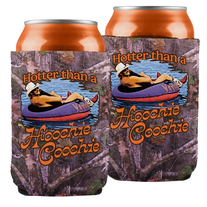Camouflage-patterned can cooler with a graphic of a man in a white hat lounging on a purple and red inflatable tube, featuring the text ’hotter than a hoovie coochie’ in orange script.
