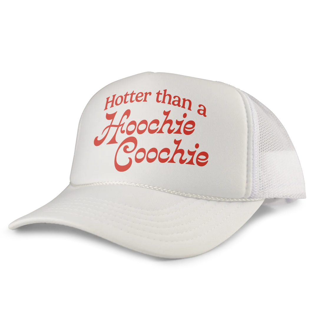 White trucker hat with red cursive text reading ’hotter than a hoochie coochie’ on the front panel.